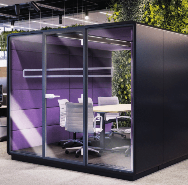 Acoustic Meet L meeting booth with purple interior, white table and chairs shown in an office space
