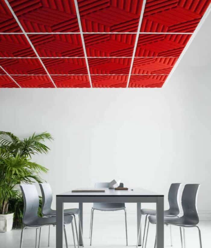 Acoustic Panels Madison panels in red shown on a ceiling in above a desk and chairs