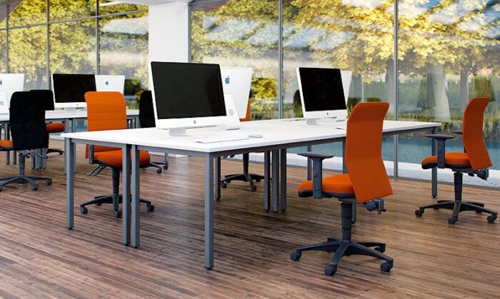 Air Task Chair group of chairs shown around a bench desk in a workspace