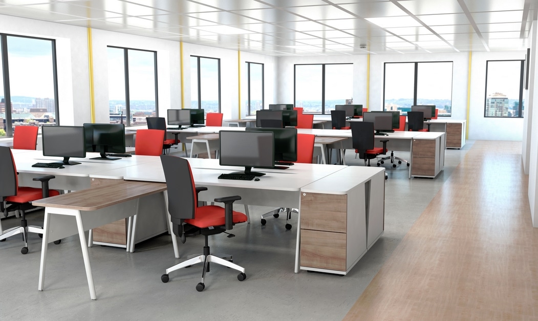 Ascend Desk - banks of back to back rectangular desks with desk high pedestals and desk returns in an open plan office space
