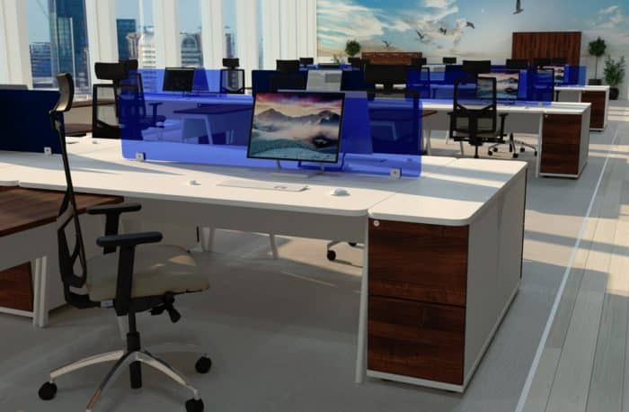 Ascend Desk - three banks of back to back rectangular desks with desk high pedestals shown in an office space