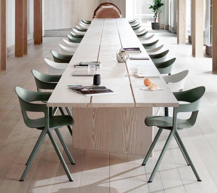 Axyl Chair & Stool twenty six armchairs shown around a long bench table in a work space