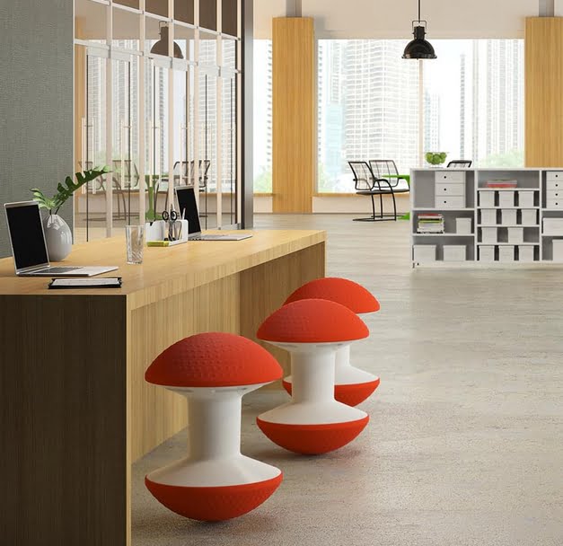 Ballo Stool 3 stools with red domes shown in front of a bench desk in a work space