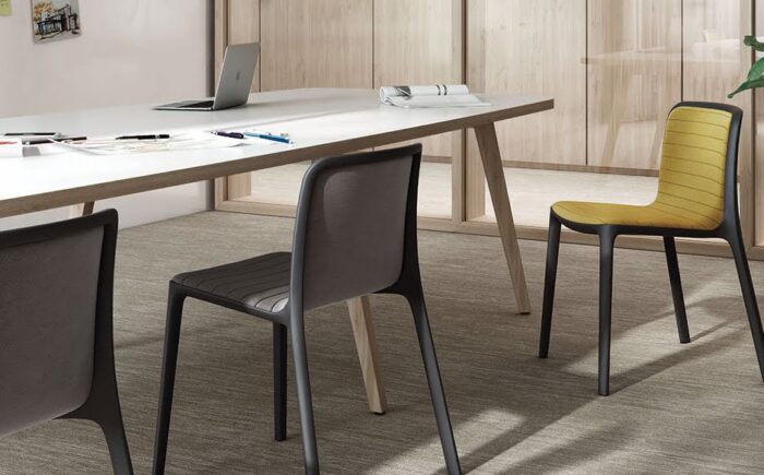 Bika Chair stripe upholstered chairs shown around a bench table in a meeting room