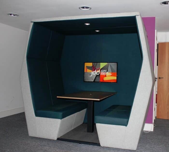 Bill Meeting Den 4 seater booth shown with lighting, table and mounted screen