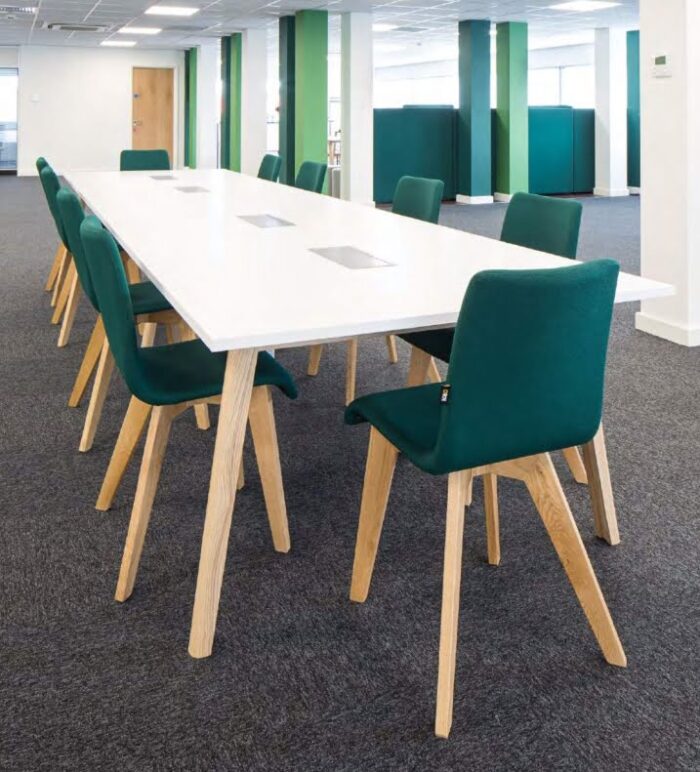 Blaze Chair & Stool ten chairs with upholstered seats and natural oak 4 leg frames shown around a rectangular meeting table in a work space