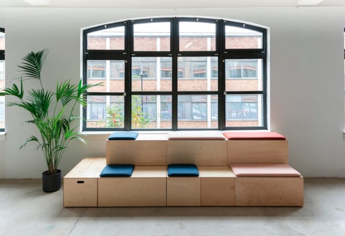 Bleachers Modular Seating large two tier straight configuration shown by a window in an office space