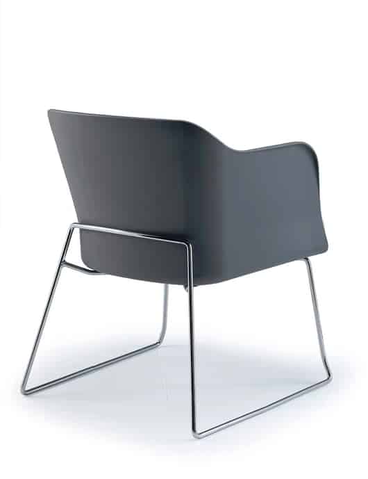 Bloom Visitor Chair rear view of chair with a black polypropylene shell, upholstered seat pad and a chrome sled frame