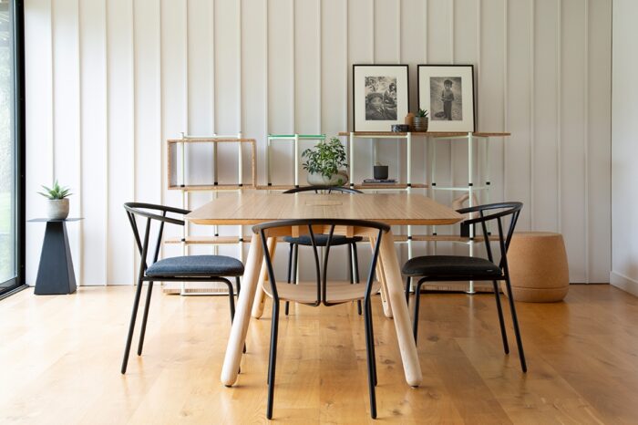 Blume Table with a sawn edge top shown in an office with four padded seat Wish chairs