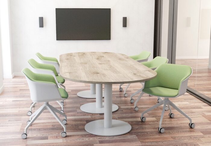 Boardroom Tables with a wood effect oval top and a white circular three pillar base shown in a meeting room