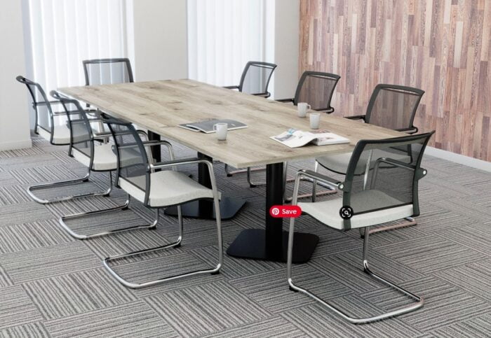Boardroom Tables with a wood effect rectangular top and a black square pillar base shown in a meeting room