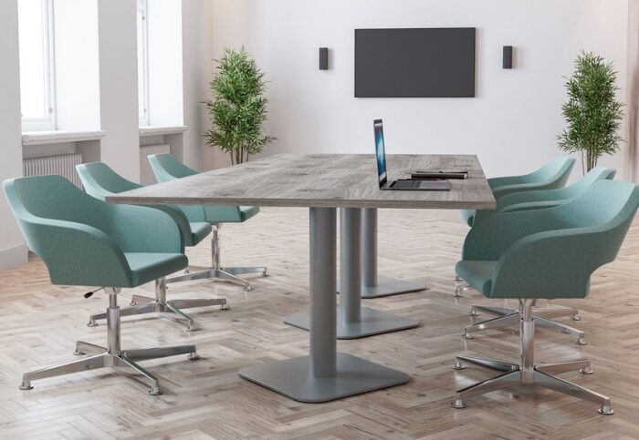 Boardroom Tables with a wood effect rectangular top and a grey pillar square base shown in a meeting room