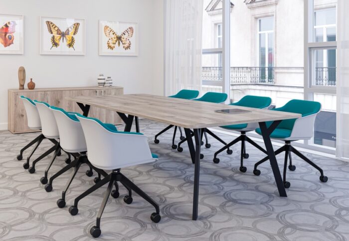 Boardroom Tables with a wood effect shaped rectangular top and a black Y leg base shown in a boardroom
