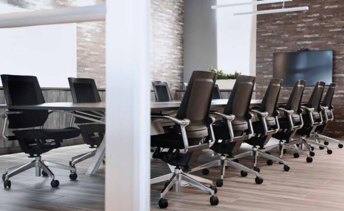 Bodyflex Task Chair 12 chairs with arms around a large table in a meeting room