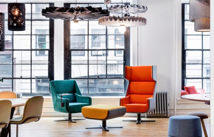BuzziMe Seating high and low back chairs shown with an ottoman in a breakout space