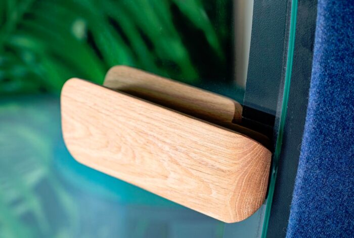 BuzziNest Phone Booth close up view of oak door handle