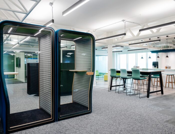 BuzziNest Phone Booth pair of booths shown side by side, with interior shelves and power modules shown in an open plan office space