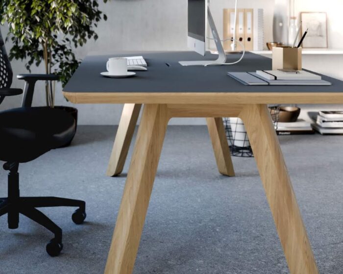 Centro Breakout Tables with concealed power, grey table top and natural oak frame, used as a single person desk in an office space