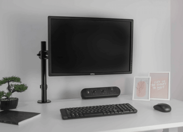 Chroma Power Module black unit shown on a desktop behind a monitor