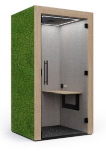 Clara Acoustic Pod with a table and a moss exterior