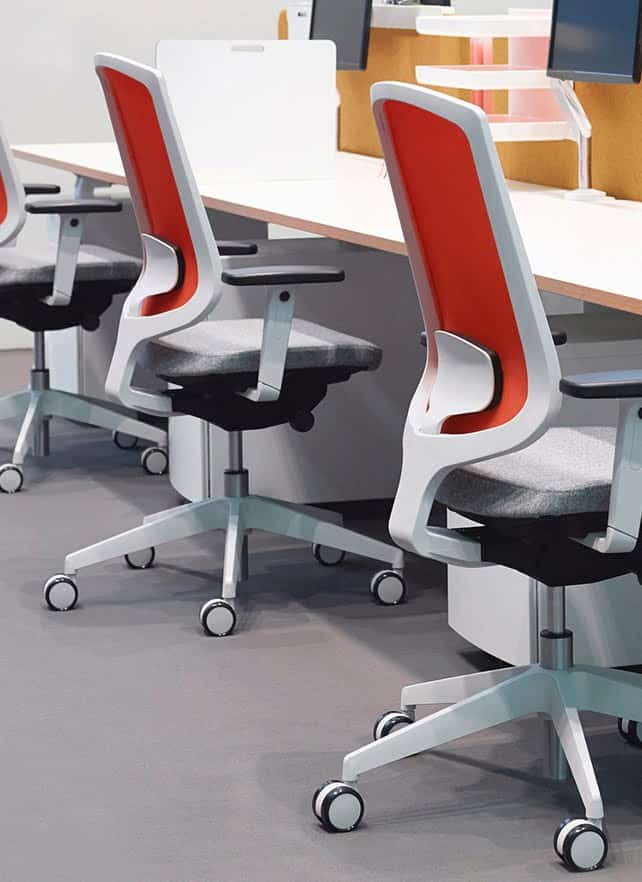 Clipper Task Chair 3 chairs with arms by a desktop