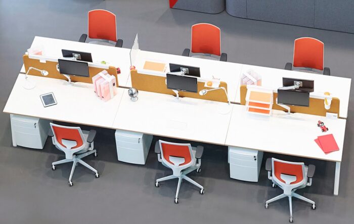 Clipper Task Chair 6 chairs with arms shown with a bench desk, desk screens and pedetals