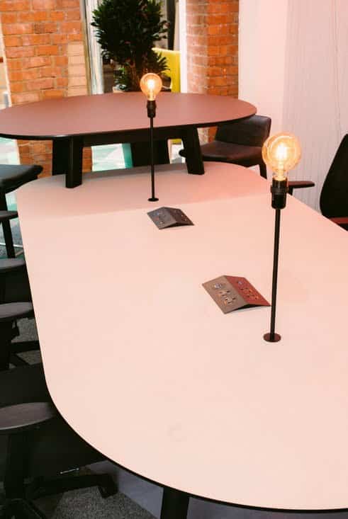 Co.Table close up of co-working table with black stained Oak frame, integrated lamps and power modules