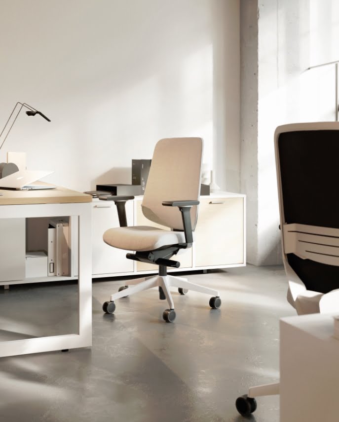 Dot.Pro Task Chair two chairs with upholstered mesh backs, white lumbar supports and white bases in front of two desks