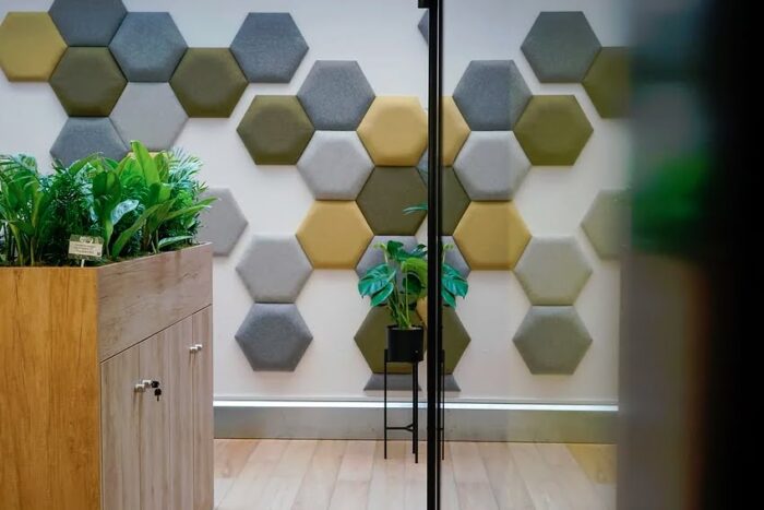 Eden Acoustic Tiles group of hexagonal tiles on a wall in a reception area
