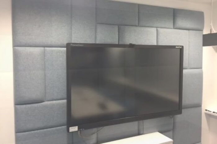 Eden Acoustic Tiles shown wall mounted behind a TV screen