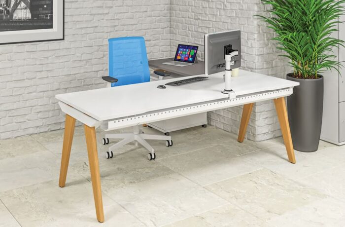 Evolution Bench single desk in white with return kit in grey, shown with a pedestal and task chair