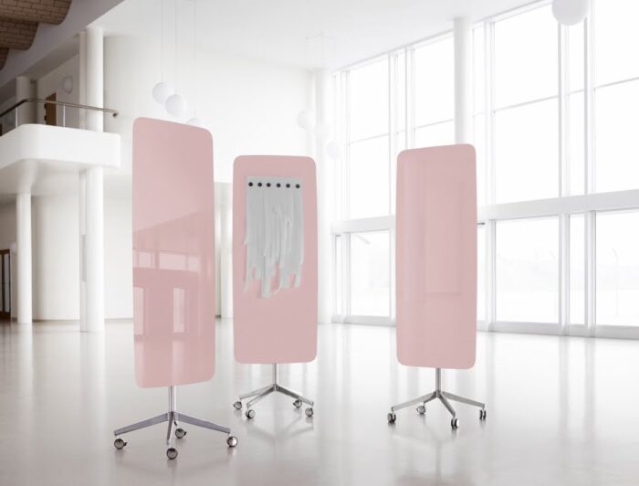 Flow Mobile Writing Board three writing boards with soft curved edges in pink finish with polished aluminium bases on castors, in an open plan office space