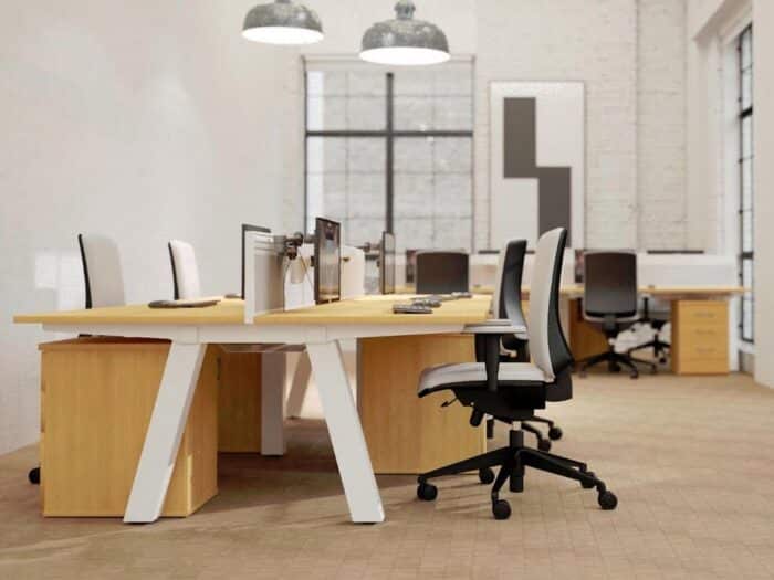 Force Bench Desk double sided desks with wood effect tops, white frames and matching pedestals in an office