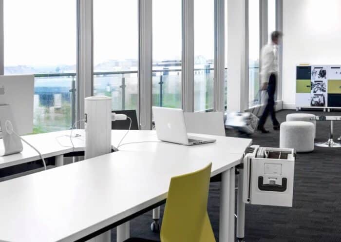 FourKonnect Tables clsoe up of an oval configuration using deltoid and rectangular shaped tops shown in an office space
