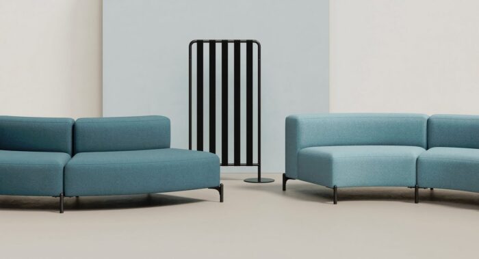 FourPeople Modular Seating curved units with blue upholstery shown with a screen