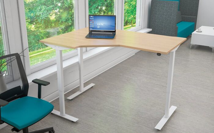 Freedom Lite Sit Stand Desk radial workstation with white trim shown in an office