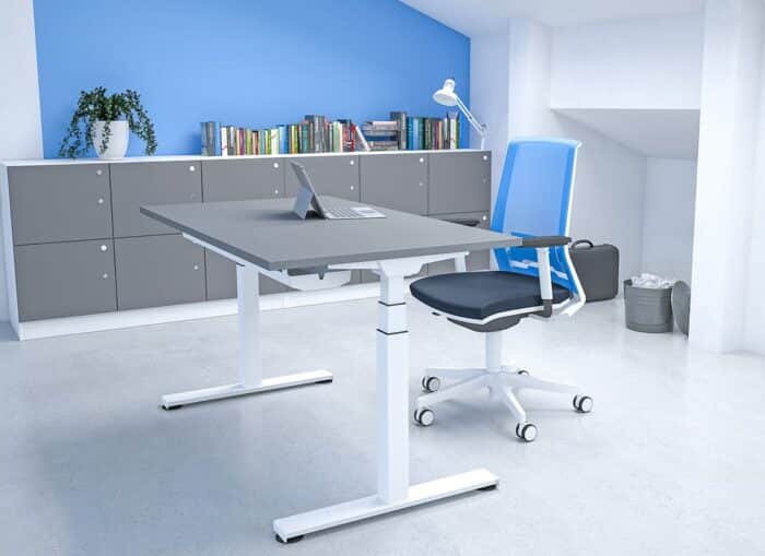 Freedom Lite Sit Stand Desk single rectangular desk with grey desktop and white trim shown in an office