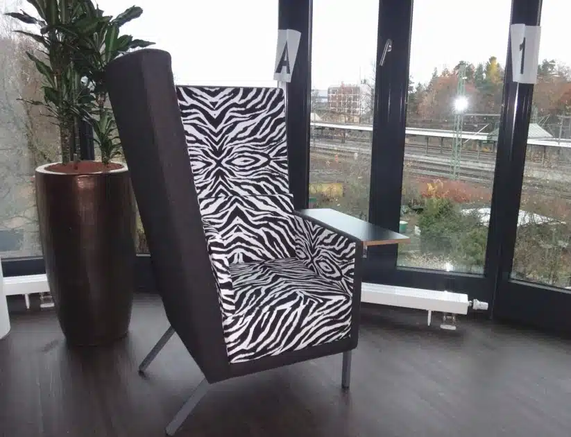Georgia Chair high back single seater with two tone upholstery and a left hand table in a breakout space