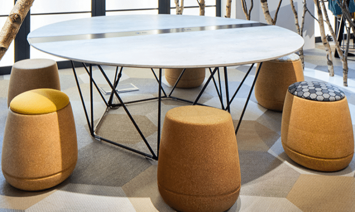 Grow Cork Stool 6 stools shown around a Foundry Giant Table in a workspace