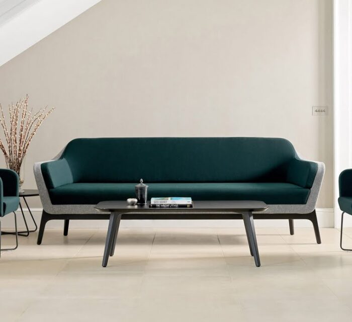Harc Soft Seating lwo back three seater sofa shown with a black powder coated 4 leg frame and a matching coffee table in a reception area