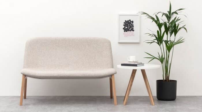 Herbie Soft Seating sofa shown with a circular coffee table, both with 4 leg wooden legs in natural finish