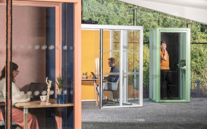 Hoozone Micro Pod with the front and one side wall glazed shown in an open plan space with a Hoozone Meeting Pod and Hoozone Phone Booth