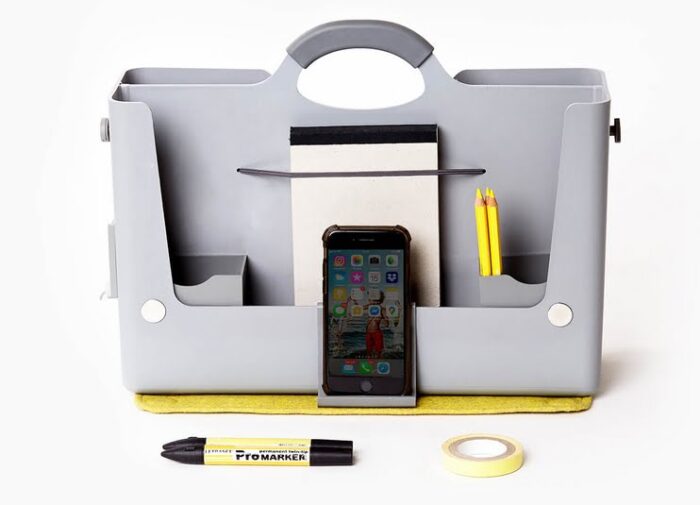 Hotbox 2 caddy in grey shown with a notebook, pens and a mobile phone