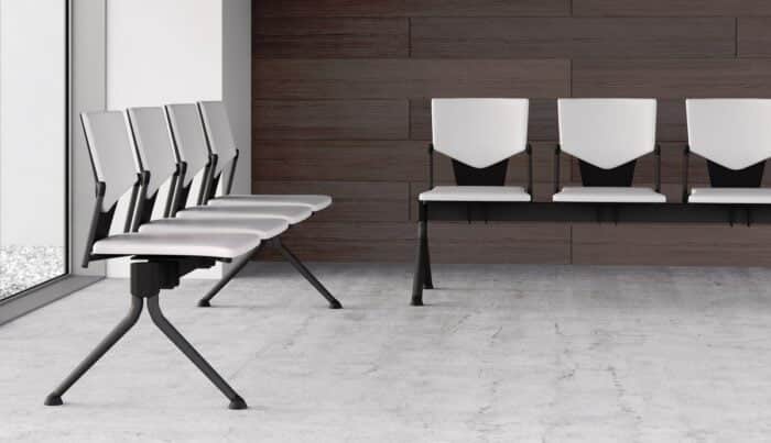 Ikon Beam Seating two 4 seat benches with upholstered seats and back in white fabric and black frames shown in a waiting room