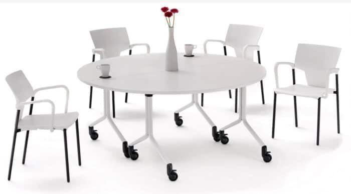 Ikon Chair group of arm chairs with white shells and black 4-leg frames shown around a table