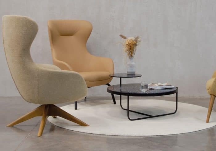Ilk Soft Seating - two high back chairs - one with a 4 star swivel wooden base and one with a 4 leg metal base, shown with an Orbit coffee table