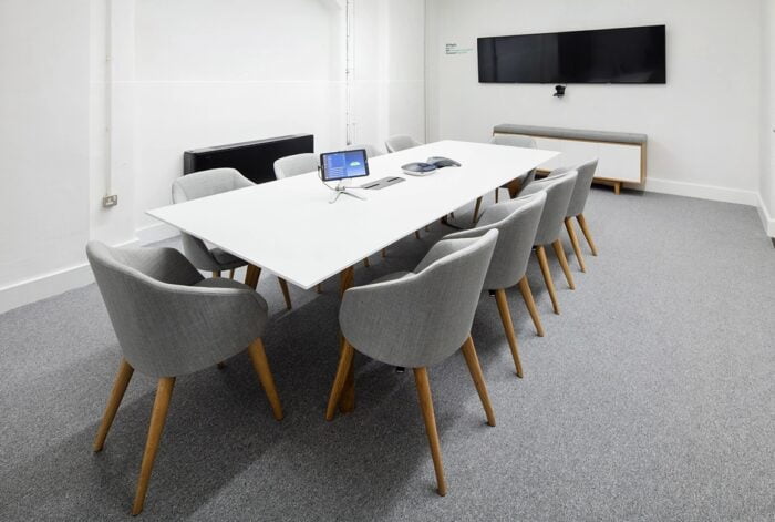 Jig Social Table shown with ten chairs in a meeting room