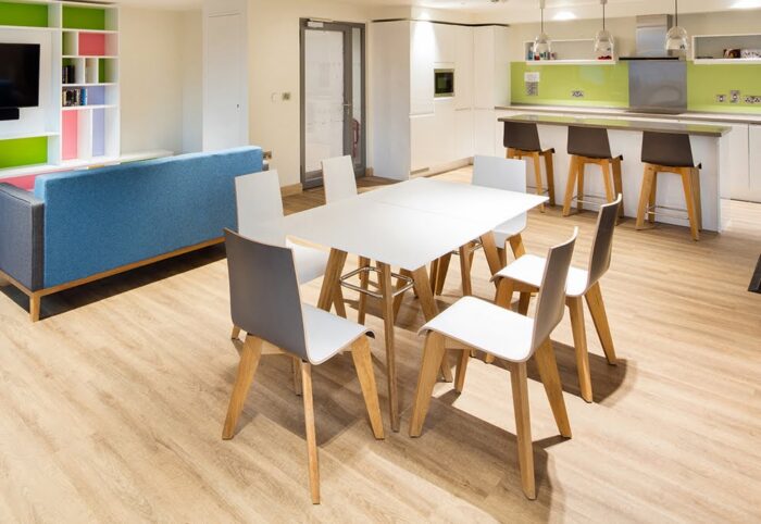 Jig Table two square diner height tables together shown with six jig laminate chairs in a breakout space