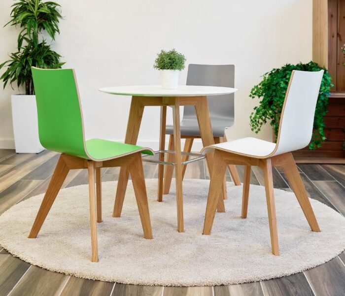 Jinx Chairs And Stools dining chairs with natural oak 4 leg frames shown with a dining height Jinx table in a breakout space