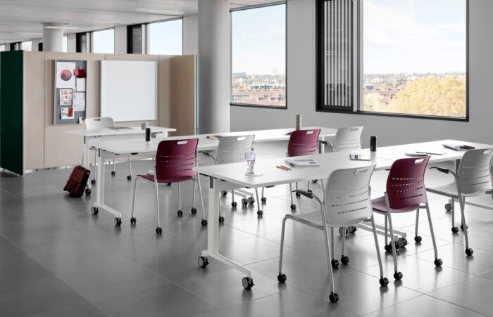 Jonny Chair 9 chairs with arms and castors shown in a training space